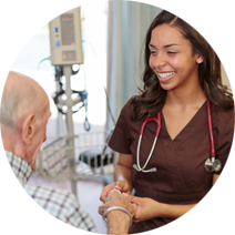 Nurse wearing brown scrub holding a patient's hand and smiling at him
